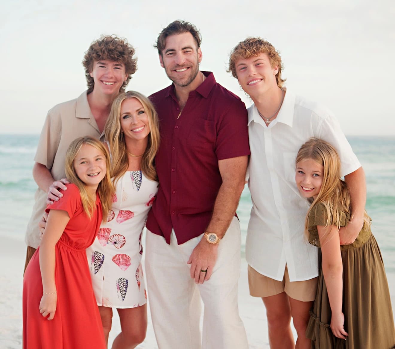 Josh and Taryn with their four children on the beach
